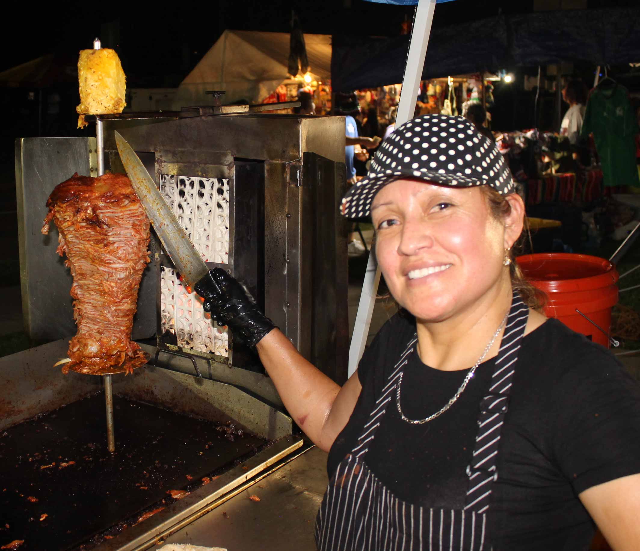 conchis spinning the trompo while smiling and posing for the camera