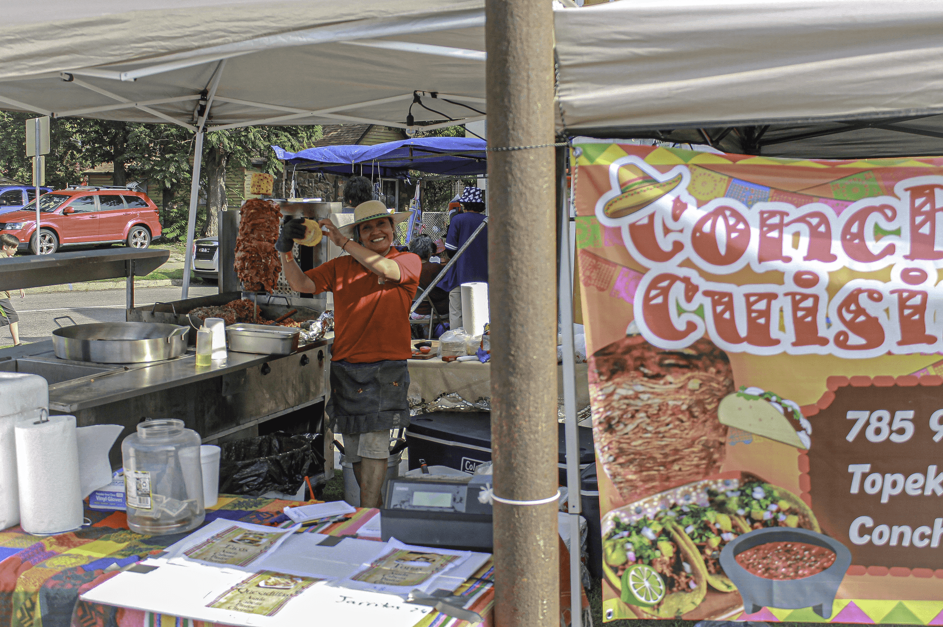 Consepcion the founder and chef, waving at the camera