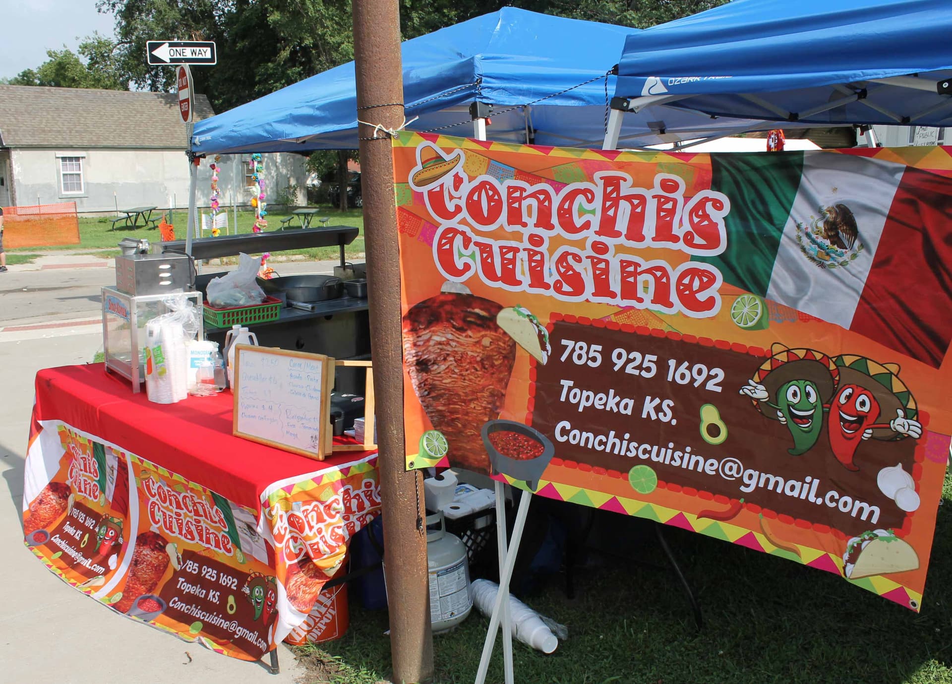 food stand being prepared with a poster in the front