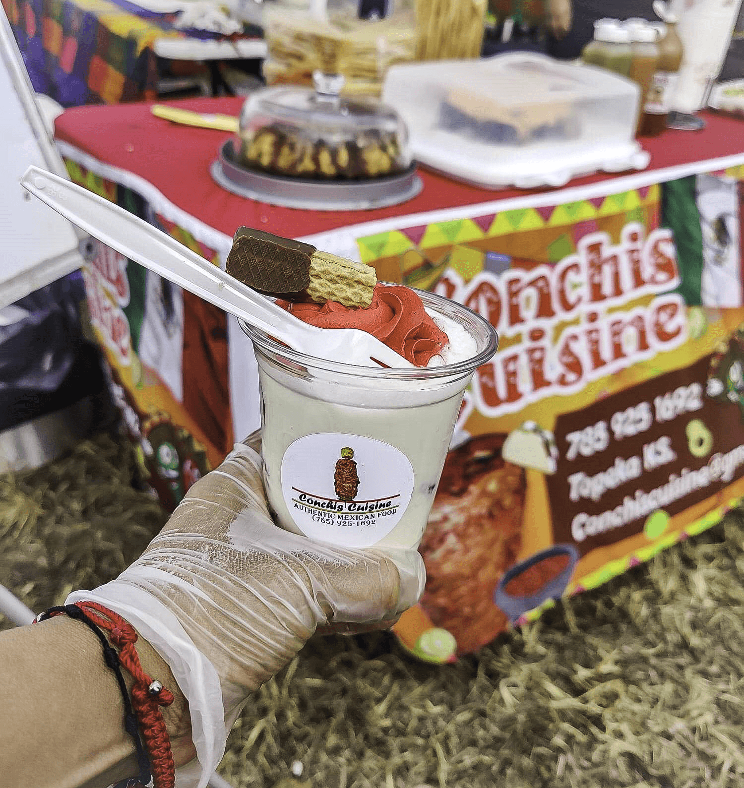 Cup of fresas con cremas with conchis cuisine sticker on the side.